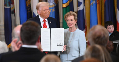 President Donald Trump and Education Secretary Linda McMahon hold up an executive order dismantling the Department of Education at the White House on March 20.