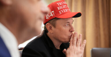 Wearing a red pro-Trump baseball-style cap, Elon Musk attends a Cabinet meeting on Monday.