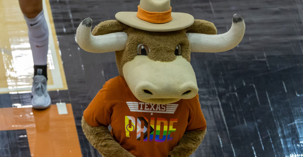 a person dressed up as the University of Texas at Austin ball mascot with a gay T-shirt that says Texas pride
