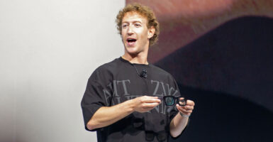 Mark Zuckerberg on the stage with a T-shirt holding special computer glasses