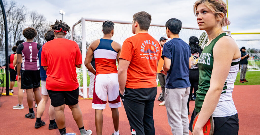 Transgender athlete Eliza Munshi waits in line to discus throw in the men's division of a districtwide track meet in Falls Church, Virginia, on March 19.