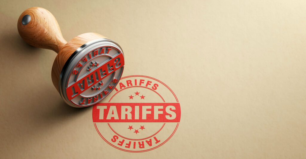 A tariff decal stamper imprinting the word "tariffs" on light brown wrapping paper
