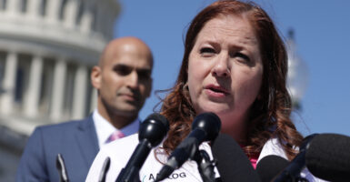 Dr. Christina Francis, CEO of the American Association of Pro-Life Obstetricians and Gynecologists, speaks as Erik Baptist, senior counsel at Alliance Defending Freedom, looks on at a Capitol news conference on March 21, 2024.