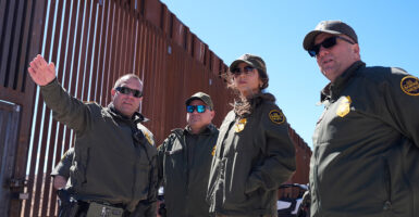 Homeland Security Secretary Kristi Noem listens during a tour along the Nogales border wall at the Mariposa Port of Entry in Nogales, Arizona, on March 15.