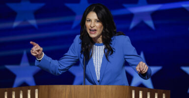 Michigan AG Dana Nessel in A blue suit on stage with a microphone