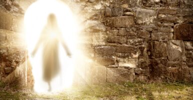 A resurrected Jesus is walking covered in light.