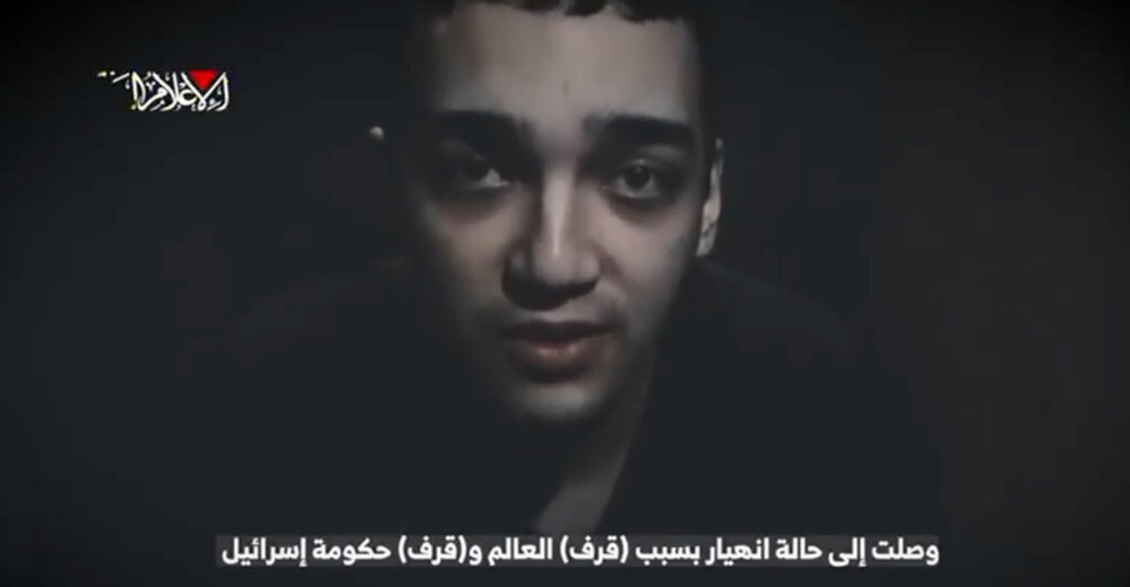 A screen grab of a video released by Hamas of American Edan Alexander. The image depicts a headshot of the haggard 21-year-old as he speaks directly into the camera.