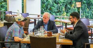 Kilmar Armando Abrego Garcia meets with Sen. Chris Van Hollen, D-Md., and his attorney sit around a table and talk.