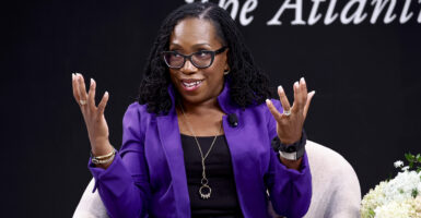 Ketanji Brown Jackson in a black dress with a blue jacket