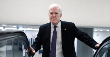 Sen. John Cornyn, R-Texas, arrives at the top of an escalator.