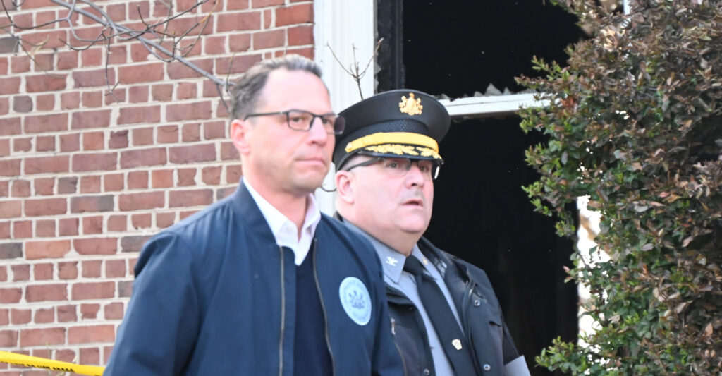 Gov. Josh Shapiro, D-Pa. with police after an arson attack at the governor's residence in Harrisburg, Pa.