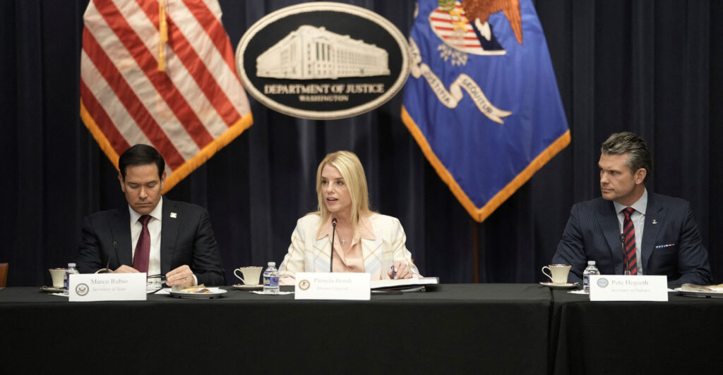 Marco Rubio, Pami Bondi, and Pete Hegseth sit together at a table covered with a black tablecloth.