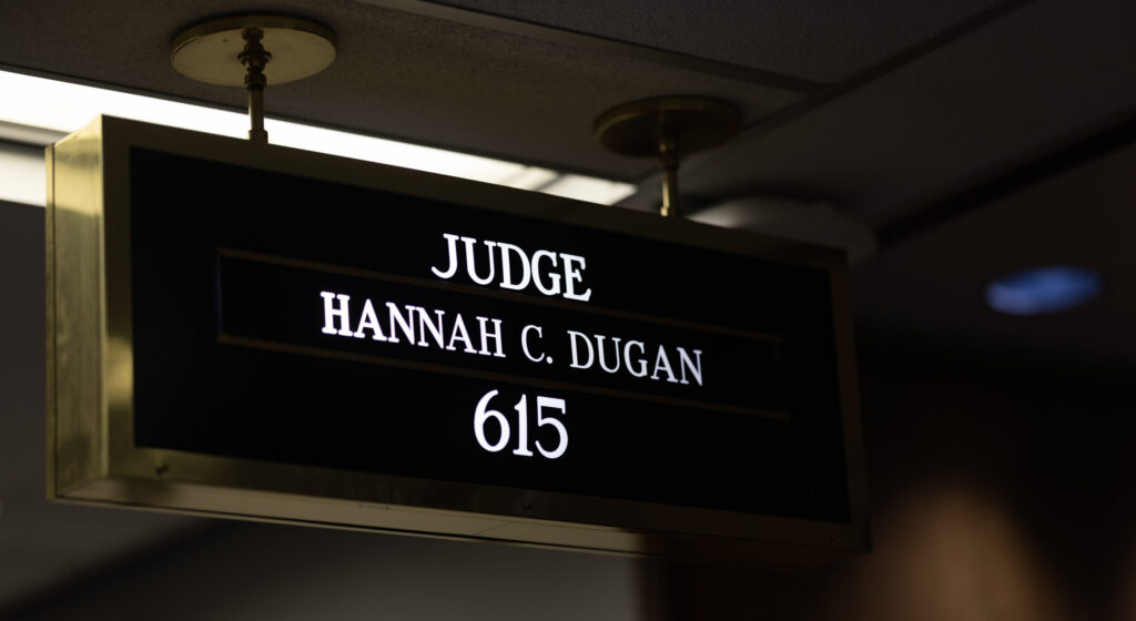 Sign with white lettering against black background reading Judge Hannah C. Dugan 615.