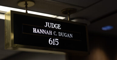 Sign with white lettering against black background reading Judge Hannah C. Dugan 615.