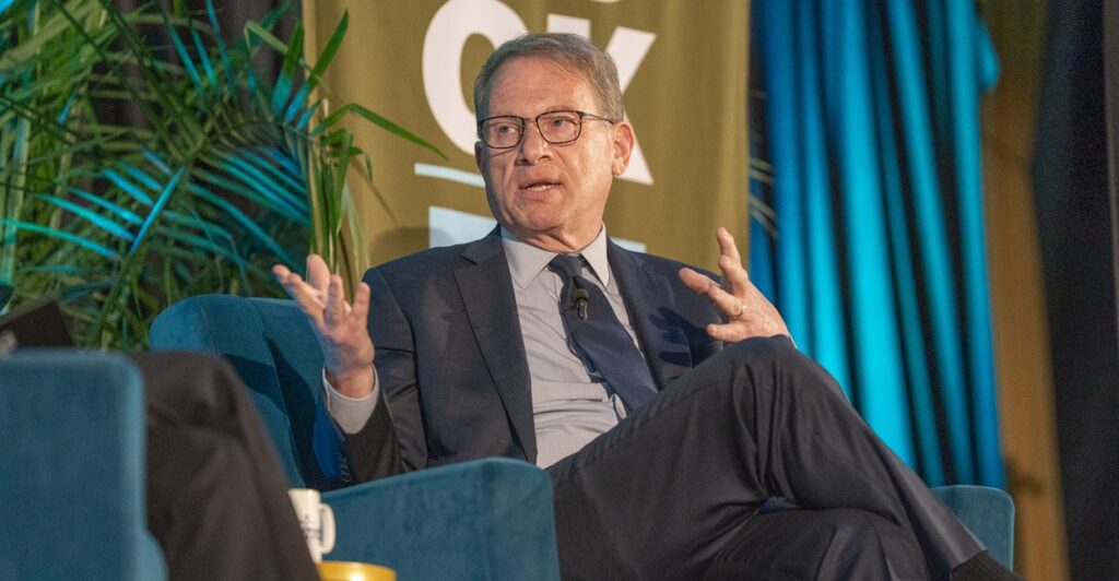 Jeffrey Goldberg sits while talking and turns to his right while gesturing with his hands.