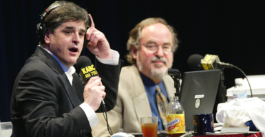Radio talk-show host Sean Hannity (left) talks conservative politics with David Horowitz on his show in front of a live audience on March 6, 2003, in Redondo Beach, Calif.