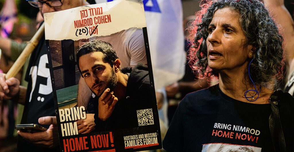 Viki Cohen, mother of Israeli hostage Nimrod Cohen, holds a hostage poster of her son during the demonstration in Tel Aviv, Israel, on Oct. 12, 2024.