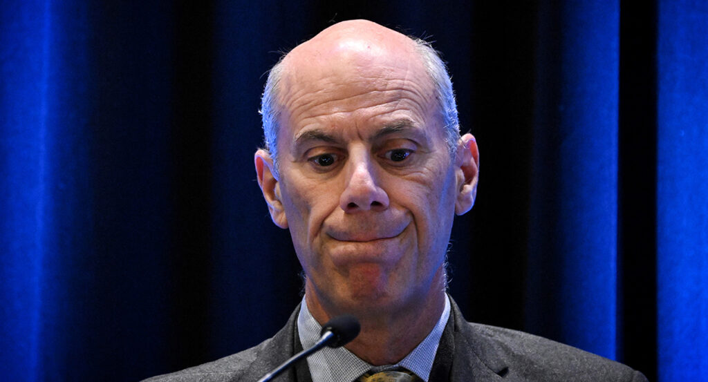 U.S. District Court Judge James Boasberg, in a suit, looking down sheepishly