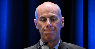 U.S. District Court Judge James Boasberg, in a suit, looking down sheepishly