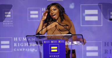 Rep. Jasmine Crockett brushes her hair back as she delivers speech to the Human Rights Campaign.