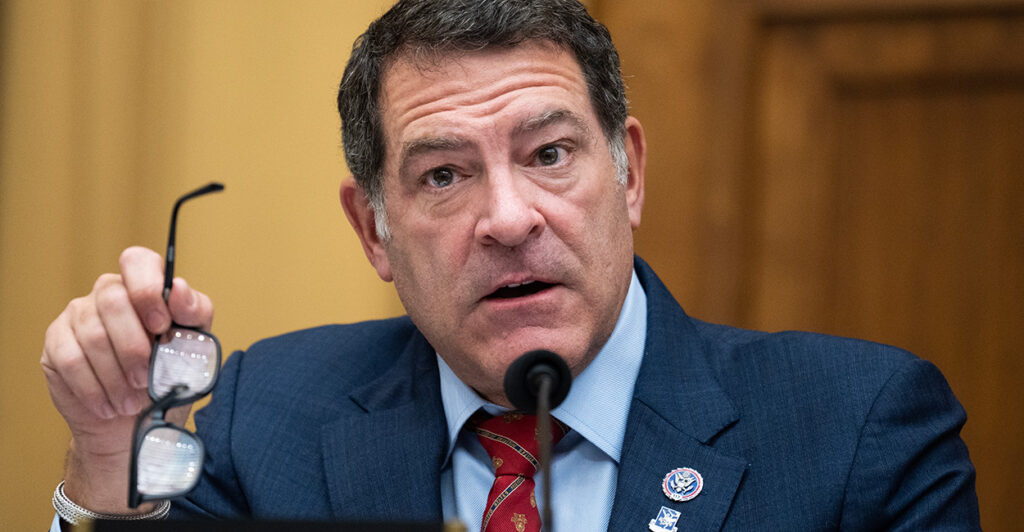 Rep. Mark Green, R-Tenn., holds his glasses in his hand