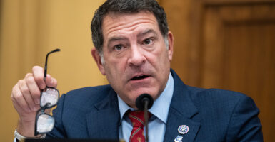 Rep. Mark Green, R-Tenn., holds his glasses in his hand