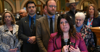 Colorado House Minority Leader Rose Pugliese in pink gestures