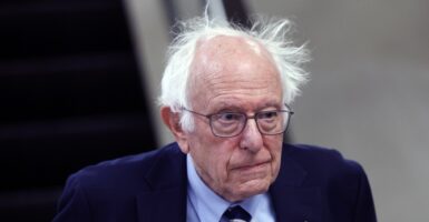 Bernie Sanders looks straight ahead as he walks to his office.