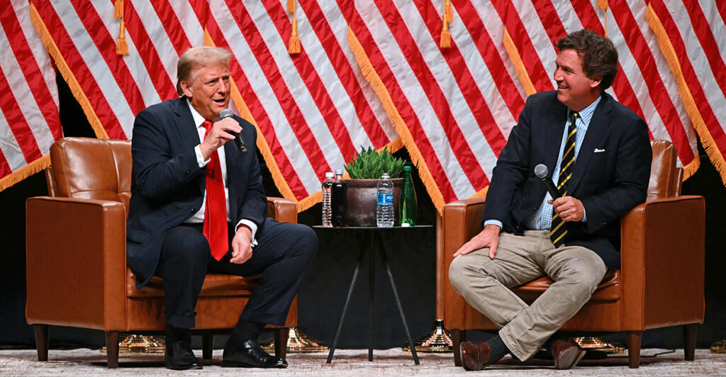 President Donald Trump speaks with Tucker Carlson at an event in Glendale, Ariz., on Oct. 31.