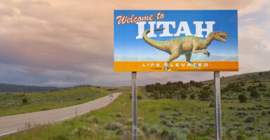 A sign by the side of a remote highway welcomes people to the state of Utah.