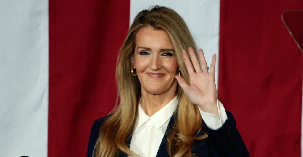 The chief of the Small Business Administration, Kelly Loeffler, waves during a visit to Vantage Plastics in Bay City, Michigan, on March 14.