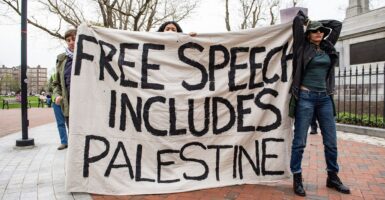 Demonstrators hold up a sign in favor of Palestine on the Harvard University campus.