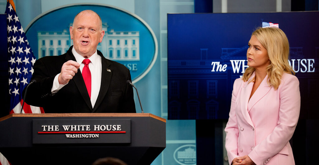 White House border czar Tom Homan, accompanied by White House press secretary Karoline Leavitt, standing at the podium in the White House press briefing room talking to the media