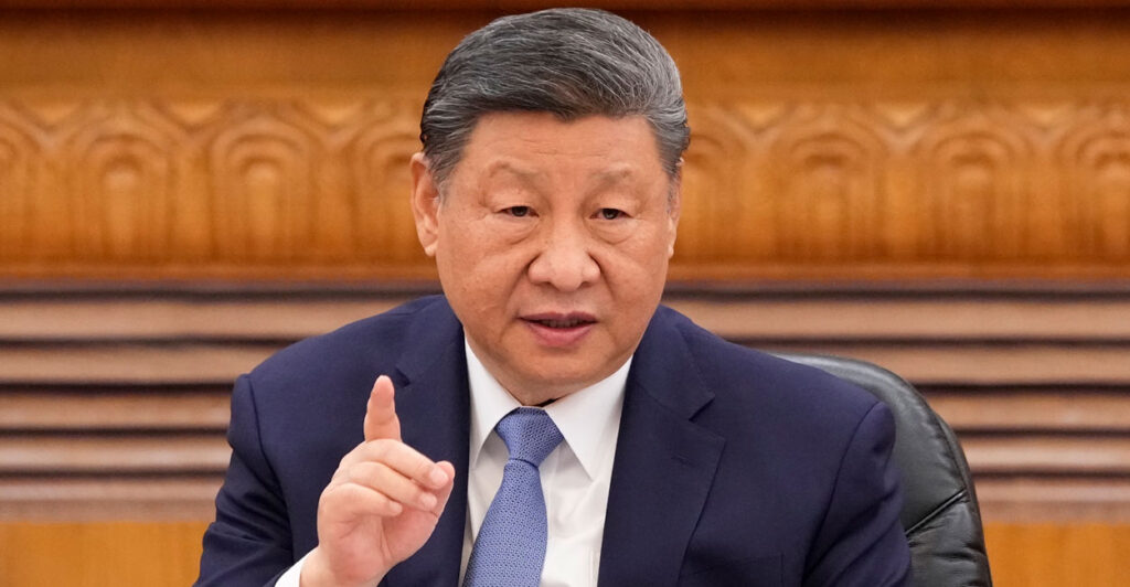Xi Jinping gestures by pointing his finger upward