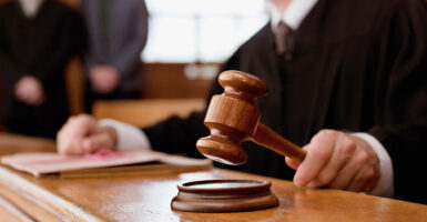 A judge hammers his gavel in a courtroom
