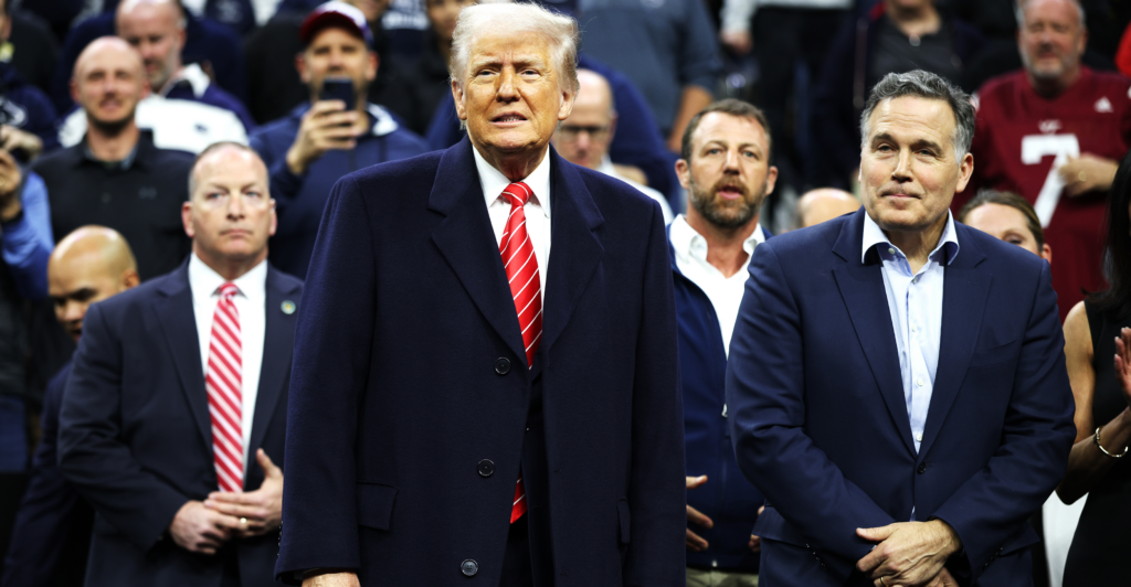 President Donald Trump attends the NCAA Division I Wrestling Championships with Sen. Dave McCormick, R-Pa., (right) on March 22 in Philadelphia.