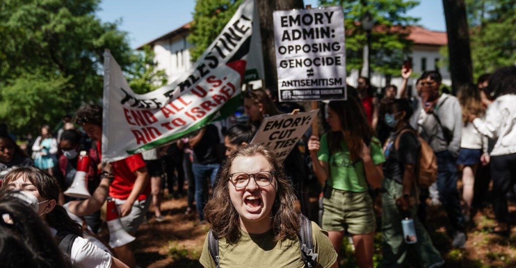 pro-Palestinian student protesters holding up signs like "opposing genocide doesn't equal antisemitism"