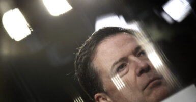 Stylized close-up of former FBI Director James Comey, with reflected light.