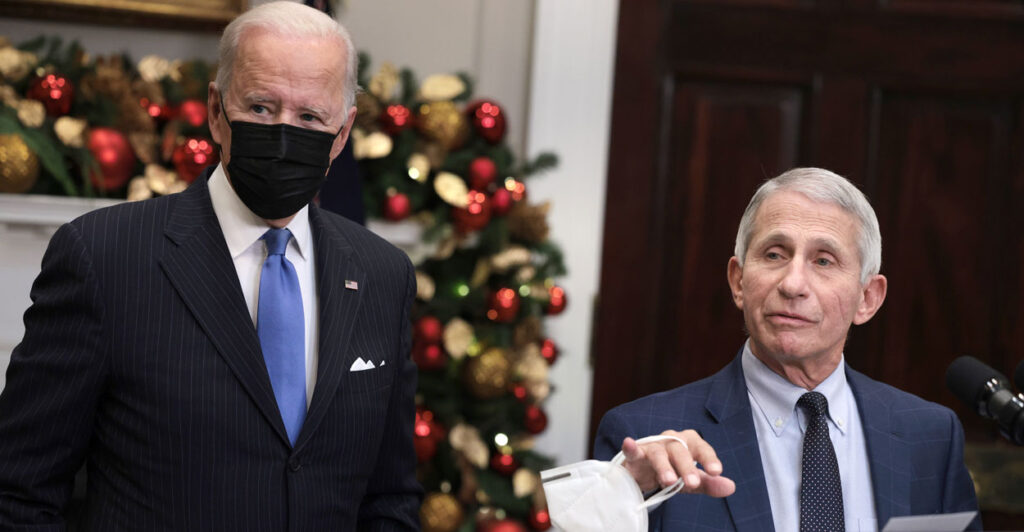 Dr. Anthony Fauci and a masked Joe Biden speak at the White House in November 2021.