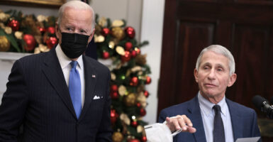 Dr. Anthony Fauci and a masked Joe Biden speak at the White House in November 2021.