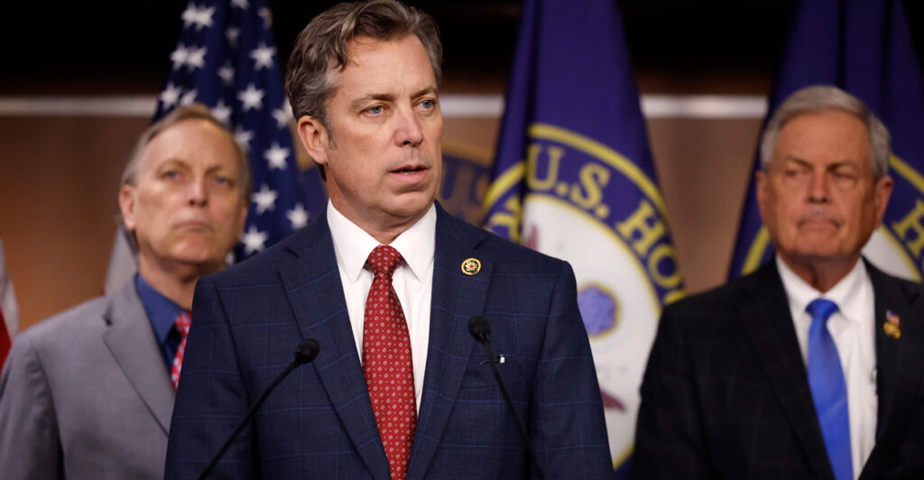 Flanked by Reps. Andy Biggs, R-Ariz. (left) and Ralph Norman, R-S.C., Rep. Andy Ogles, R-Tenn., talks to reporters on March 5, 2024, in Washington.
