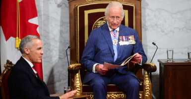 King Charles III delivers a speech from the throne in the Canadian Parliament as Canadian Prime Minister Mark Carney looks on in Ottawa, Ontario, the nation's capital, on Tuesday.