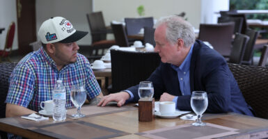 Sen. Chris Van Hollen, D-Md. meets with Kilmar Abrego Garcia at an outdoor restaurant