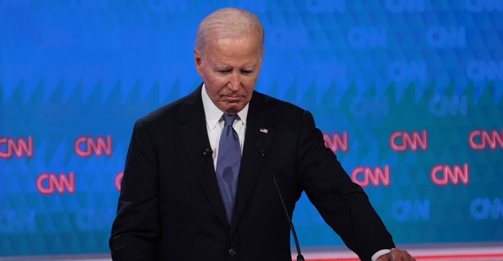 Joe Biden looks down as he pauses during a debate with Donald Trump.