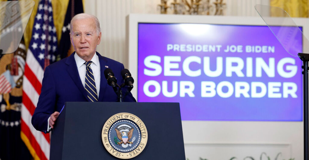 Joe Biden stands behind a podium while a sign behind him says, "Securing Our Border".