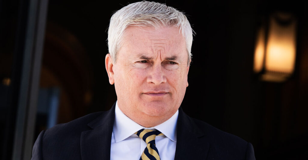 House Oversight Committee Chairman James Comer steps out of a building in a black jacket and striped tie