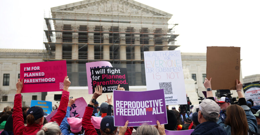 Pro-abortion protestors hold signs reading "I'm for Planned Parenthood," and "Reproductive Freedom for All" outside the U.S. Supreme Court.