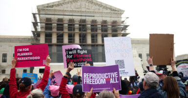 Pro-abortion protestors hold signs reading "I'm for Planned Parenthood," and "Reproductive Freedom for All" outside the U.S. Supreme Court.