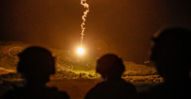 Taiwanese soldiers stand guard as flares are fired during a Taiwanese military live-fire drill, after Beijing increased its military exercises near Taiwan on Sept. 6, 2022.