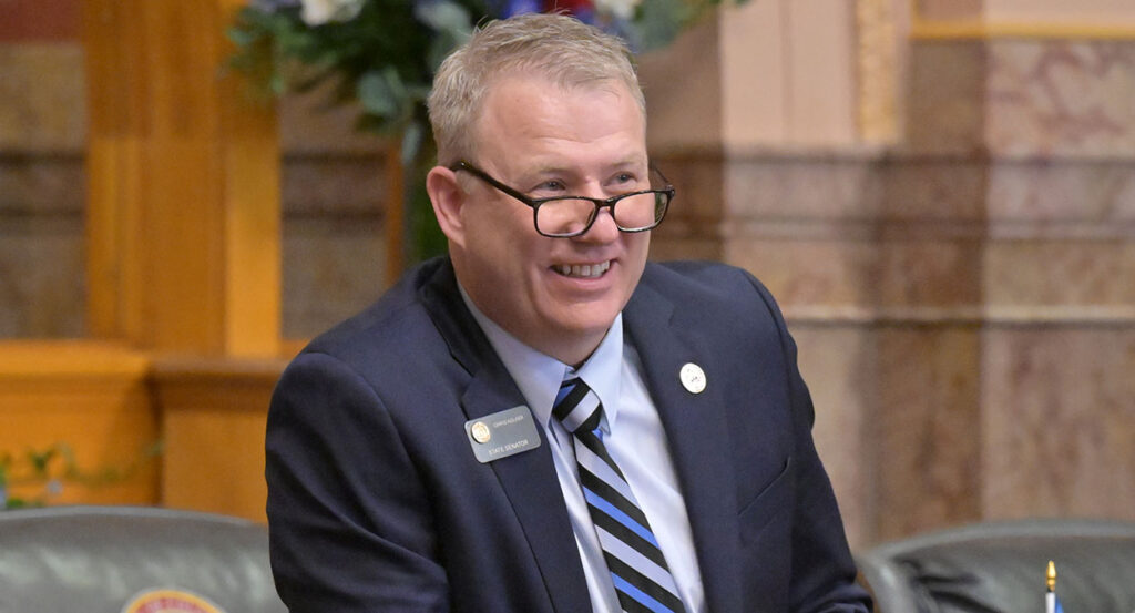 Colorado state Sen. Chris Kolker in a blue suit with a striped tie